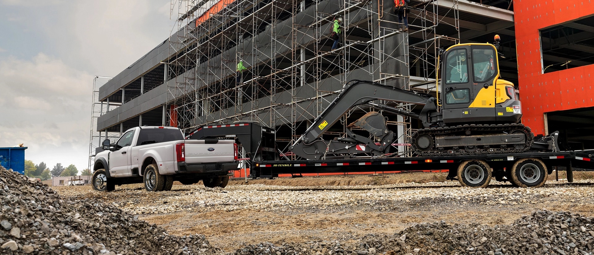 Side view of Super Duty with a backhoe on its trailer