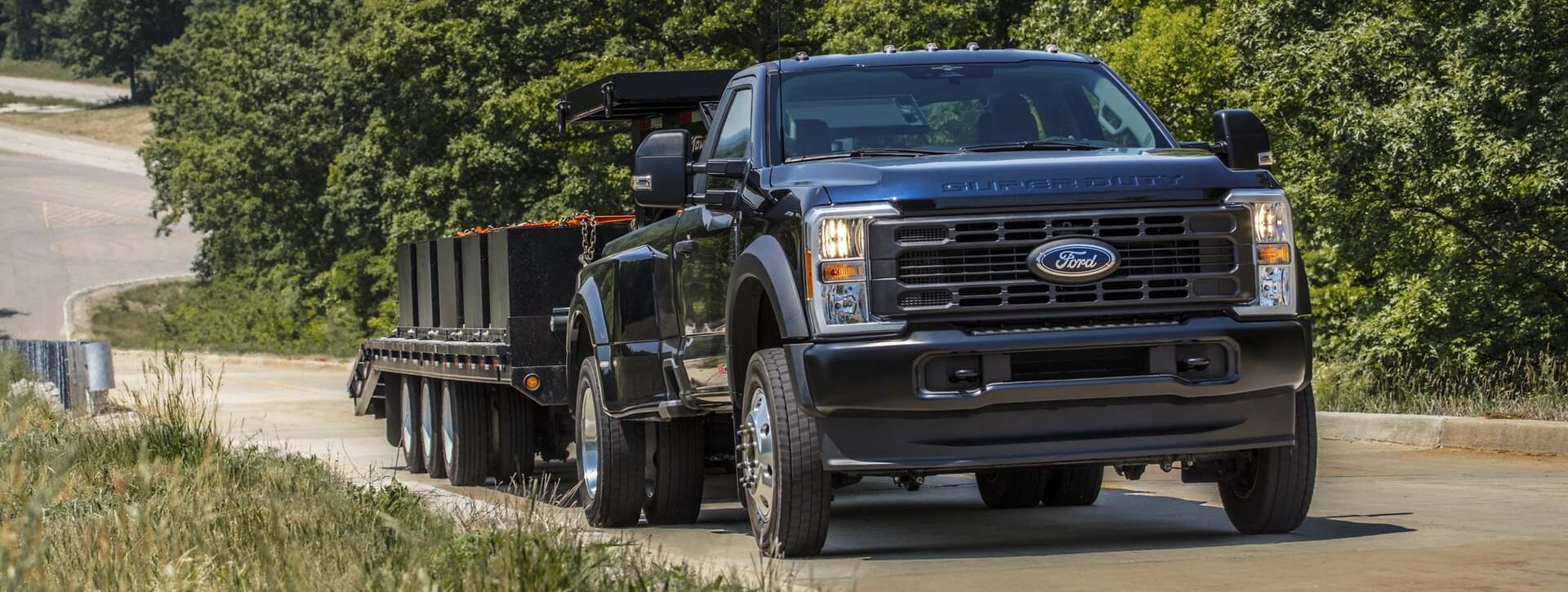 2026 Ford Super Duty driving on road with trailer